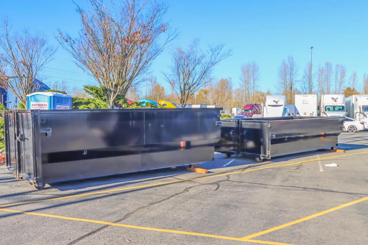Professional dumpster rental service with roll-off container on residential driveway in Fife
